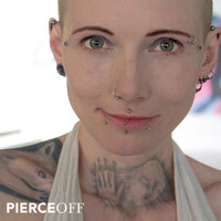 Alternative woman with multiple piercings spiked labret